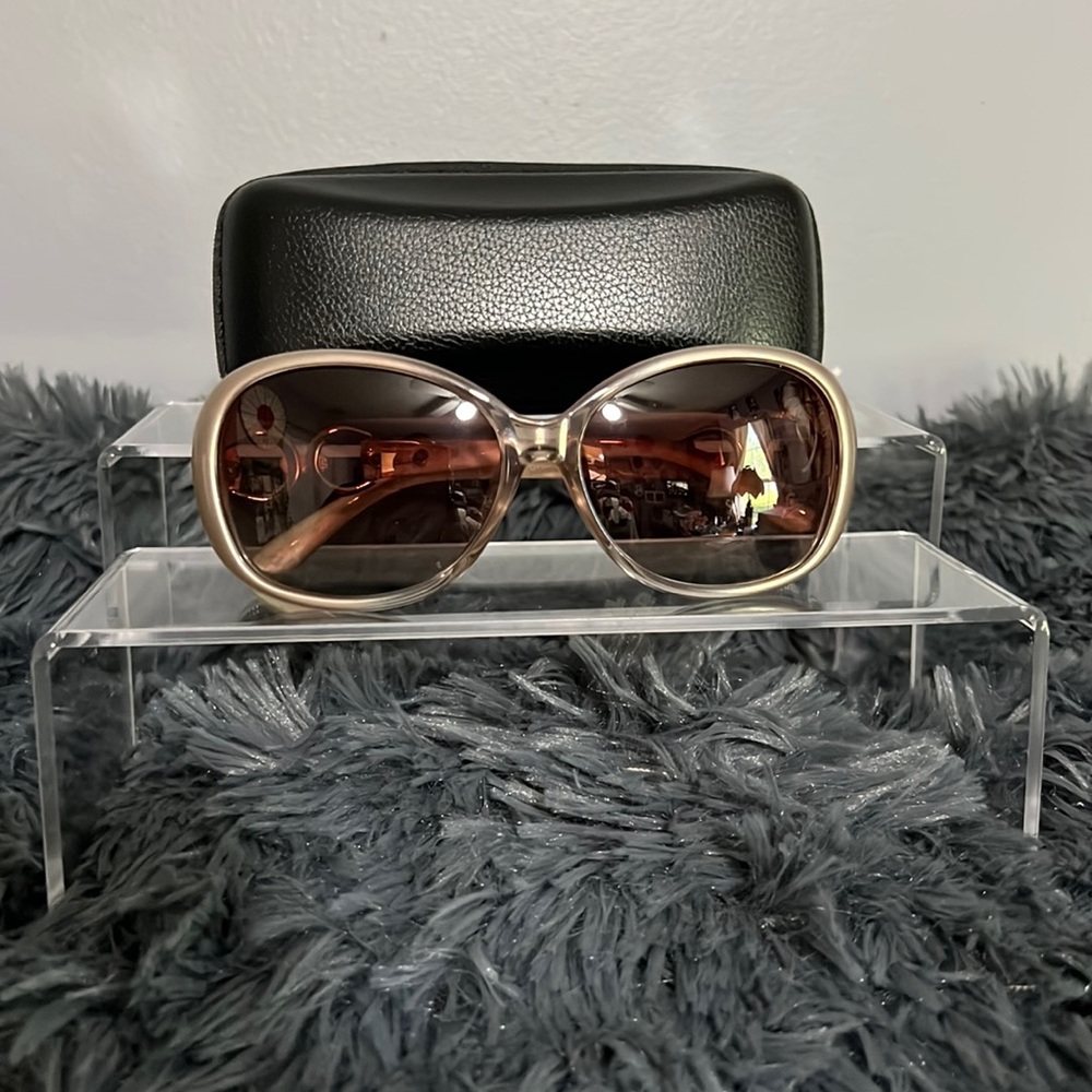 Beige sunglasses with cleaning cloth and zipper case.